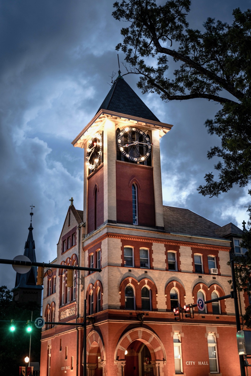 New Bern's historic City Hall clock tower lit up at dusk